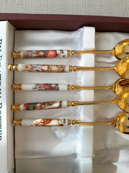Set of 5 stainless steel gold spoons with Peter Rabbit illustrations on the handles